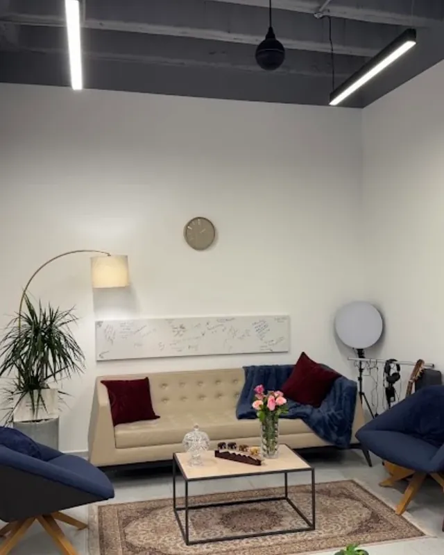 A relaxed room with a sofa, armchairs and a rug